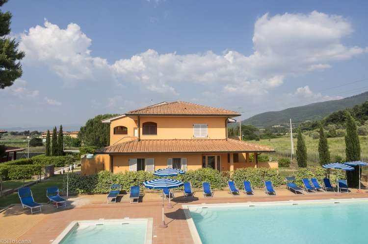 Bildet viser hus med ferieleiligheter og basseng på Vicino Mare ved kysten sør i Toscana.