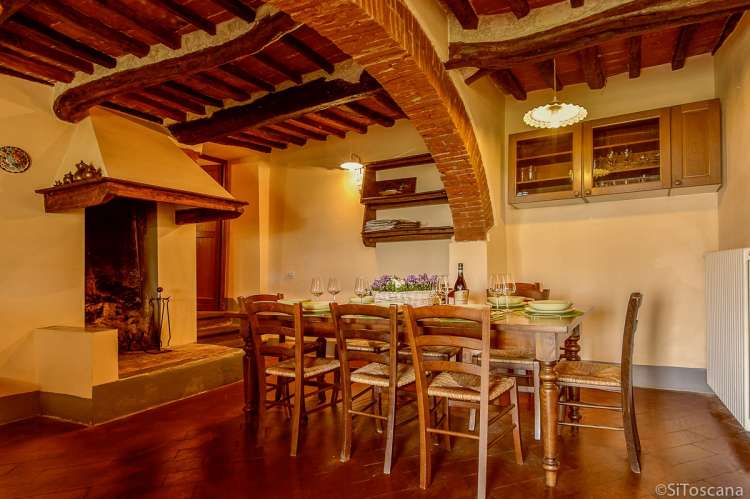 Bildet viser kjøkkenet i 1. etg. i Villa Pace. Spisebord og stor peis.