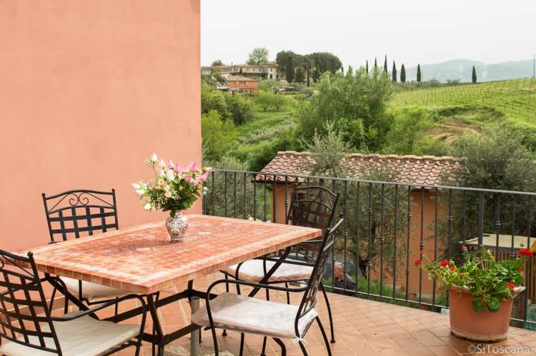 Foto av terrassen til ferieleiligheten Rosso. Utsikt til vinmarker i Chianti.
