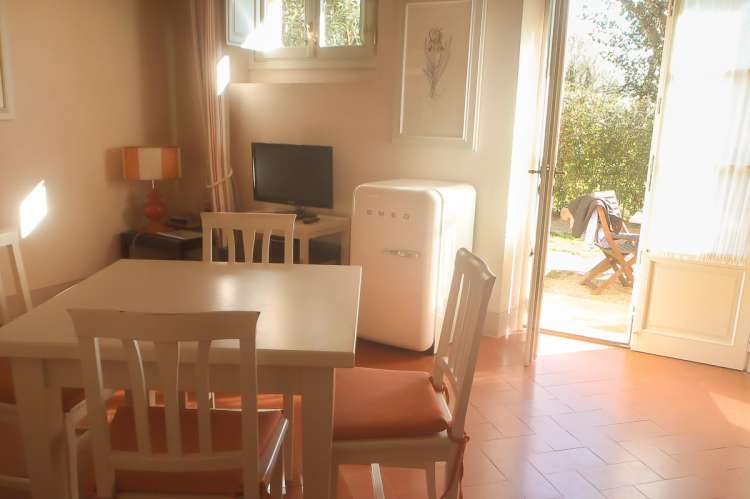 Bildet viser stue med utgang til terrasse i feriebolig nært sjøen i Toscana.