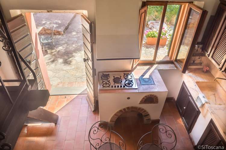 Bildet viser kjøkken med direkte utgang til terrasse i ferieboligen Casa Rosa ved Pisa.