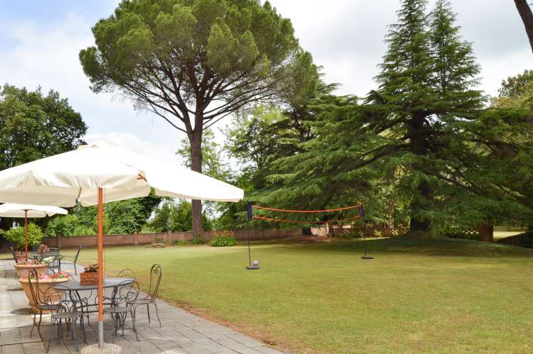 Bildet viser terrasse og hage utenfor stort, barnevennlig feriehus i Toscana.