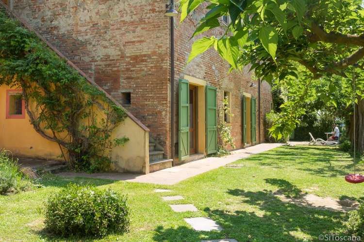 Bildet viser steinhus på barnevennlig olivengård nært Pisa og Firenze i Italia.