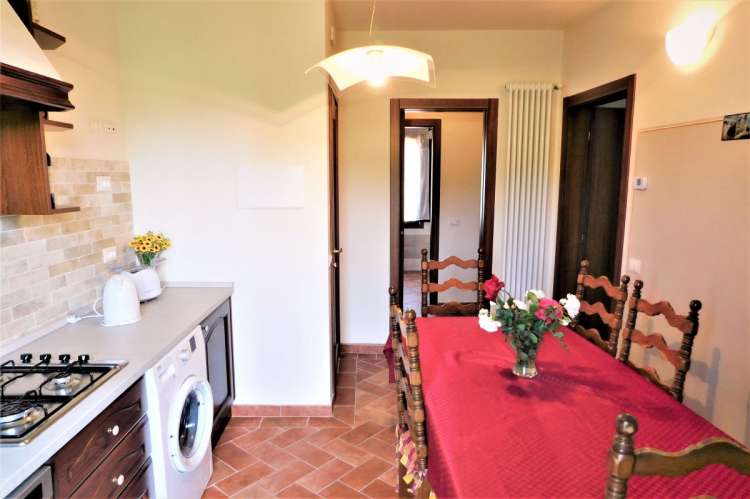 Bildet viser kjøkken med spisebord i feriebolig på vingård i Italia.