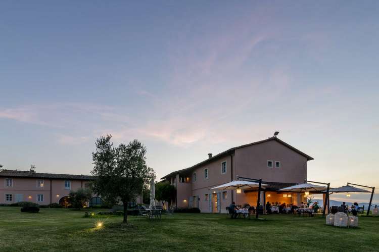 Bildet viser restaurant med uteservering om kvelden på vingård nært Pisa.
