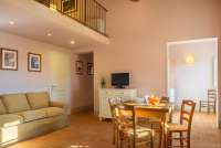 Bildet viser oppholdsrom med hems i ferieleiligheten Sangiovese på vingård ved Pisa i Toscana.