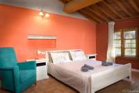 Bildet viser soverom med dobbeltseng i leiligheten Colombaia på vingården Borgo Etruschi formidlet av SiToscana.