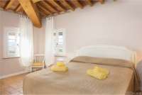 Bildet viser ett av soverommene i ferieleiligheten Torre på vingården Borgo Etruschi i Toscana. Formidlet av SiToscana.